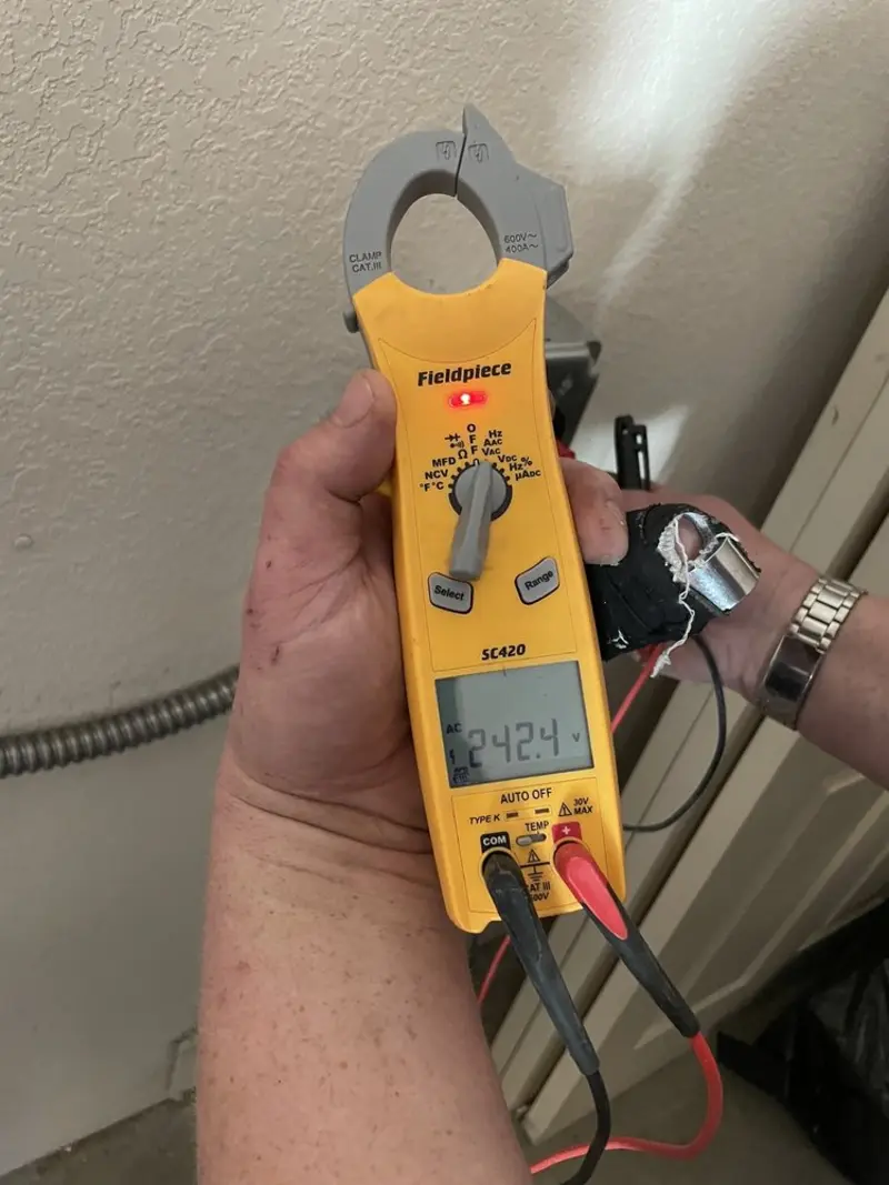 Voltage testing with clamp meter during Outlet Installation in Devine